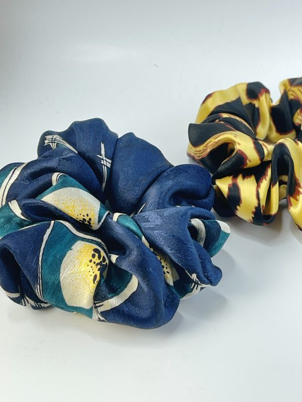 Photo of two scrunchies, one blue and one yellow and black