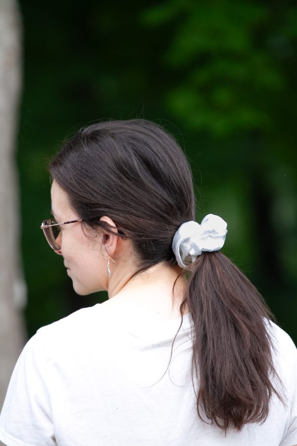 a young woman wearing a scrunchie