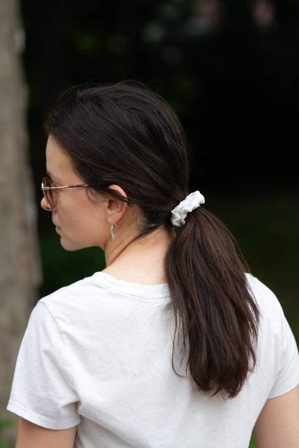 image of a young woman wearing a white scrunchie