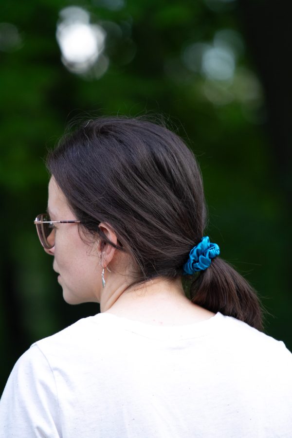 image of a young woman wearing a blue scrunchie