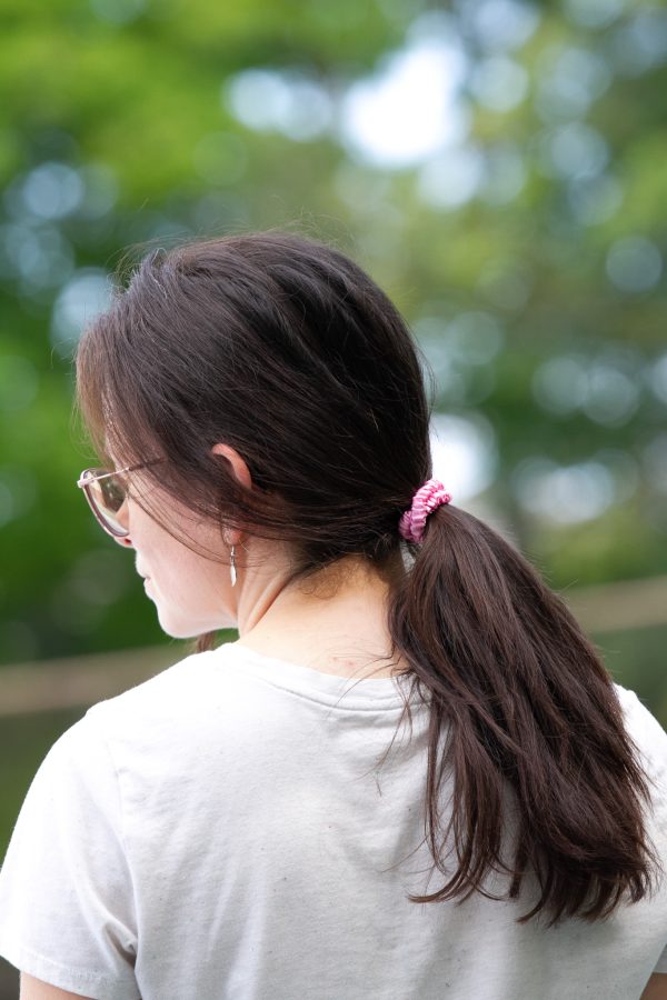 image of a woman wearing a pink mini scrunchie
