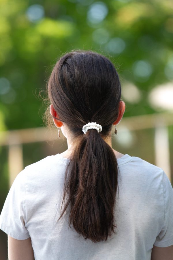 a young woman wearing a white mini scrunchie