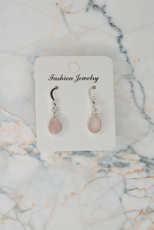 rose quartz pendant earring on marble