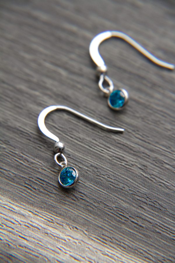 blue topaz earrings on wood